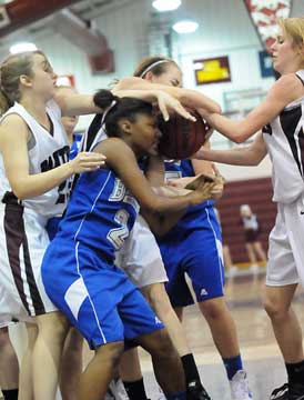 Bryant's Jayla Anderson (2) mixes it up inside against a trio of Benton players in Monday's rugged contest at Benton. (Photo by Kevin Nagle)