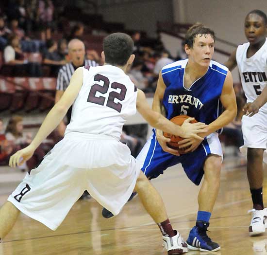 Bryant's Brandan Warner tries to split the double team of Benton's Sam Baker (22) and Ketiran Jones (5). (Photo by Kevin Nagle)