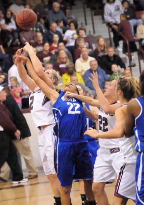 Kiara Moore (22) fights for a loose ball between Benton's Korie Parker, left, and Bailey Gately (22). (Photo by Kevin Nagle)