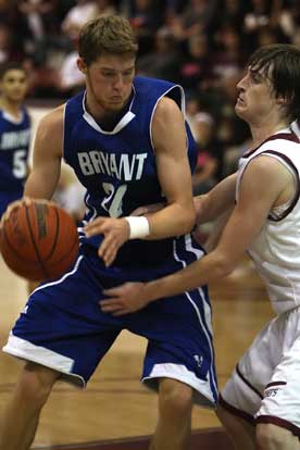 Bryant's Quinton Motto (34) starts to make a move on Benton's Zach Stuckey. (Photo by Rick Nation)