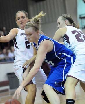 Bryant's Haley Murphy gains control of the ball between a pair of Benton defenders. (Photo by Kevin Nagle)