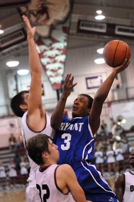 Bryant's C.J. Rainey tries to get a shot up over Benton's Graham Gardner. (Photo by Kevin Nagle)