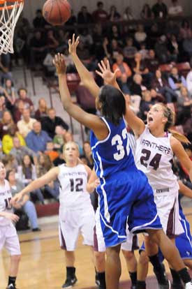 Bryant's Taneasha Rhode (32) launches a shot over Benton's Madi Brooks (24). (Photo by Kevin Nagle)