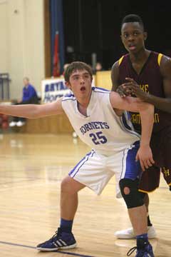 Bryant's Ryan Hall (25) tries to post up on an inbounds play against Lake Hamilton's Jason Burks. (Photo by Rick Nation)