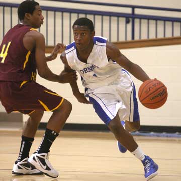 Bryant's K.J. Hill, right, drives around Lake Hamilton's Donnell West (4). (Photo by Rick Nation)