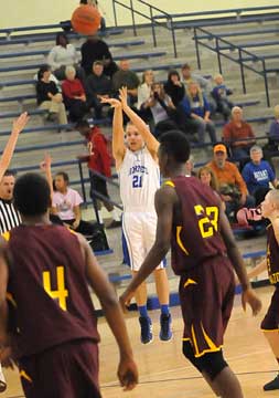 John Winn (21) launches a buzzer-beating 3 to end the first quarter. (Photo by Kevin Nagle)