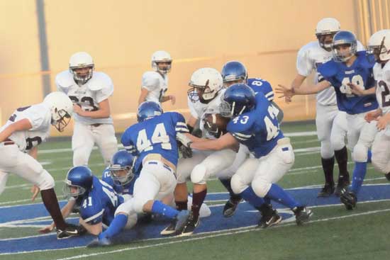 Devin Howard (44), Peyton Robertson (43) and J.P. Marrero (89) converge on Benton's Drew Dyer with Jake Hall (48), Dillon Blue (41) and Austin Fason (42) trying to get in on the play. (Photo by Kevin Nagle)