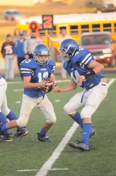 Quarterback Gunnar Burks drops back as Devin Howard (44) steps up to protect. (Photo by Kevin Nagle)