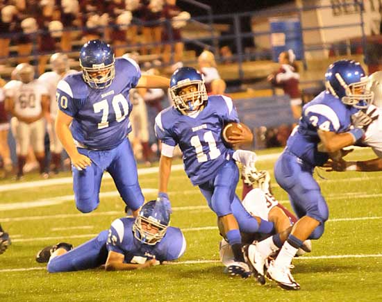 Sprung by blocks from Zack McConnell (76), Caleb McElyea (70), and Brushawn Hunter (34), Mar'Kevius Nelson (11) begins an 86-yard touchdown run. (Photo by Kevin Nagle)