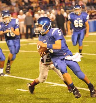 Quarterback Brandan Warner scoots upfield off blocks by Caleb Chaffin (66) and Zack McConnell (76). (Photo by Kevin Nagle)