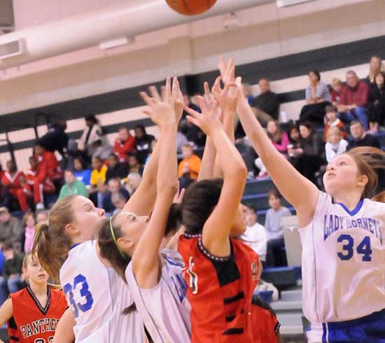 Anna Turpin (33), Kailey Nagle and Annie Patton (34) battle for a rebound. (Photo by Kevin Nagle)