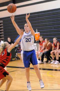 Jordan McKnight (20) shoots over a defender. (Photo by Kevin Nagle)