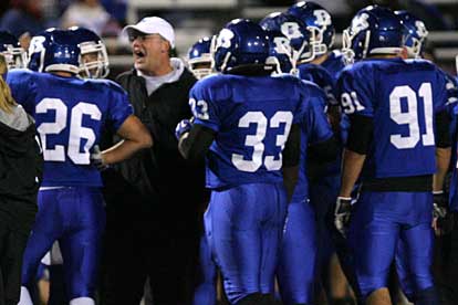 Bryant defensive coordinator Steve Griffith gives his group instruction during a timeout. (Photo by Rick Nation)
