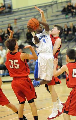 Bryant's K.J. Hill (4) drives into Vilonia's Garrett Brown. (Photo by Kevin Nagle)