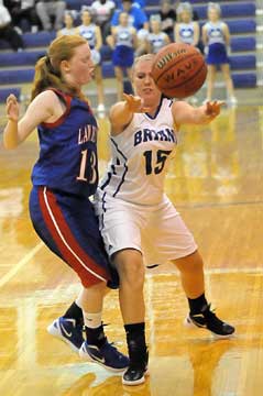 Bryant's Brittney Ball (15) passes past Deshnie Carter. (Photo by Kevin Nagle)