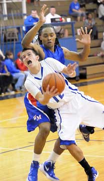 Brantley Cozart drives around West Memphis' Christian Carson. (Photo by Kevin Nagle)