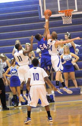 Bryant's Quinton Motto (34) goes up to try to block a shot by Andrew Ricks in front of Strodney Davis (11) and Anthony Black (10). (Photo by Kevin Nagle)