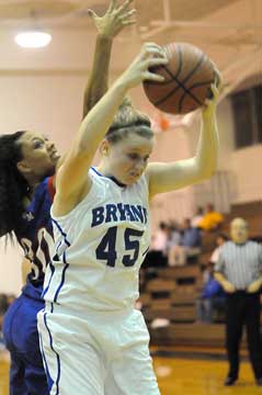 Haley Murphy grabs a rebound in front of West Memphis' Cora Winn. (Photo by Kevin Nagle)