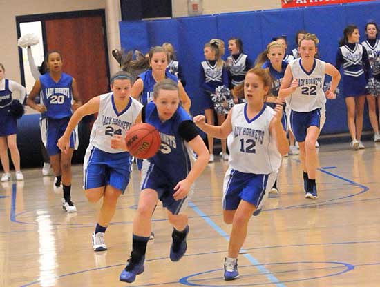 Bryant White's Skylar Davis races up the floor with Bryant Blue's Kara Moser (12) and Peyton Ramsey (24) on her heels. (Photo by Kevin Nagle)