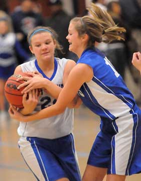 Bryant Blue's Peyton Ramsey (24) and Bryant White's Reagan Smith battle for possession. (Photo by Kevin Nagle)