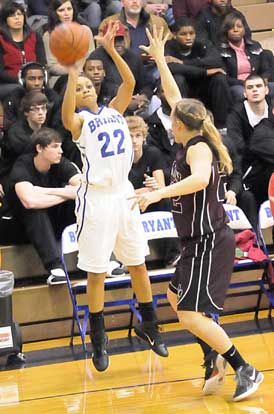 Kiara Moore (22) shoots over Benton's Boo Gately. (Photo by Kevin Nagle)