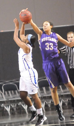 CAC's freshman Syndie Jones (33) blocks a shot by Bryant's Dez Duckworth. (Photo by Kevin Nagle)