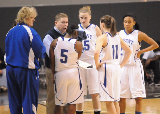 Bryant coaches Monica Parish, left, and Brad Matthews give instructions to Dezerea Duckworth (5), Haley Murphy (45), Logan Davis (11) and Kiara Moore (20) during a timeout Thursday. (Photo by Kevin Nagle)