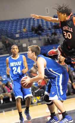 Zach Cambron (middle) takes aim at a shot after faking Maumelle's Ron James into the air while Jalen Hewett (24) gets into position for a rebound. (Photo by Kevin Nagle)