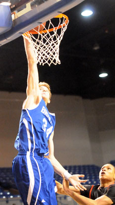 Quinton Motto throws down his second dunk in as many games, posterizing Maumelle's Kendall Donnerson. (Photo by Kevin Nagle)