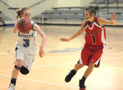 Nikki Clay tries to drive past Cabot South's Danielle McWilliams. (Photo by Kevin Nagle)