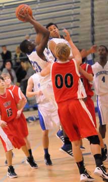 J.C. Newborn goes high for a shot in front of Cabot South's Brett Frazier (00) and alongside teammate Marcus Withers. (Photo by Kevin Nagle)