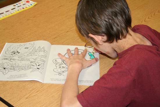 Brian Curtis, a student at Bethel Middle School, enjoys his recycling coloring book provided by the Saline County Regional Solid Waste Management District.  The SCRSWMD handed out approximately 8,000 recycling coloring books to Saline County students to promote recycling education on Nov. 17-18.