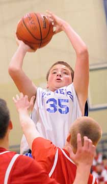 Dagin Carden (35) shoots over a pair of Cabot South defenders. (Photo by Kevin Nagle)