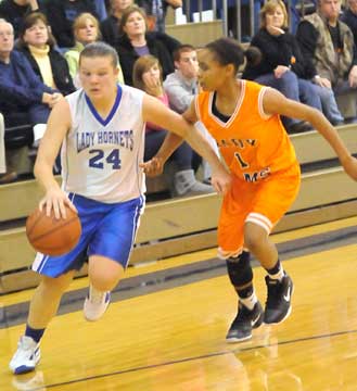 Peyton Ramsey drives around a Ridge Road player. (Photo by Kevin Nagle)