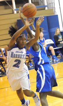 Jayla Anderson fires a shot around a North Little Rock defender. (Photo by Kevin Nagle)