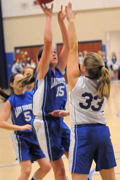 Bryant White's Lara White (15) shoots over Bryant Blue's Anna Turpin (33). (Photo by Kevin Nagle)