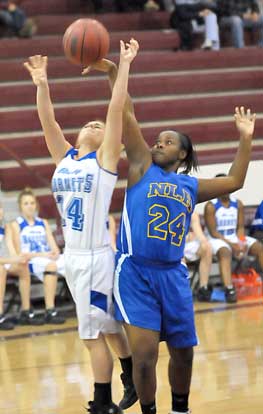 Caylin Choate (14) of Bryant has her shot knocked away by North Little Rock's Rakeithia Collins. (Photo by Kevin Nagle)