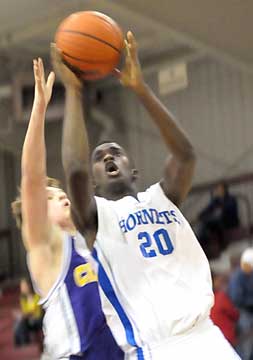 Greyson Giles goes up for a shot in front of a Catholic defender. (Photo by Kevin Nagle)