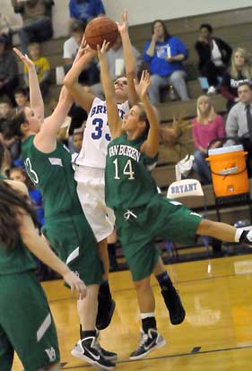 Bryant's Abbi Stearns is fouled on a shot by Mallory Brown, left, and Keri Arnold (14). (Photo by Kevin Nagle)