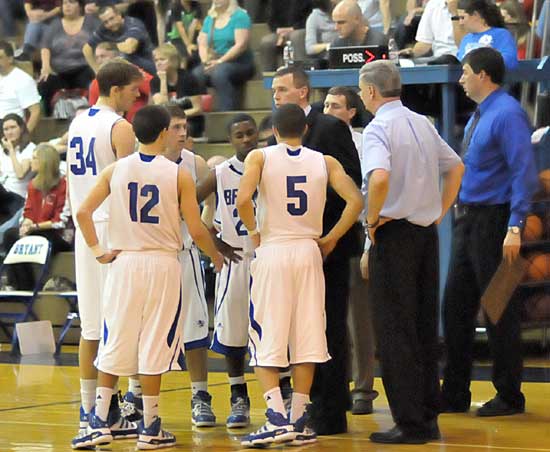 Bryant coaches Mike Abrahamson huddles with Quinton Motto (34), Brantley Cozart (12), Kyle Nossaman, Marcus Wilson and Jordan Griffin (5) during a timeout Friday night. (Photo by Kevin Nagle)