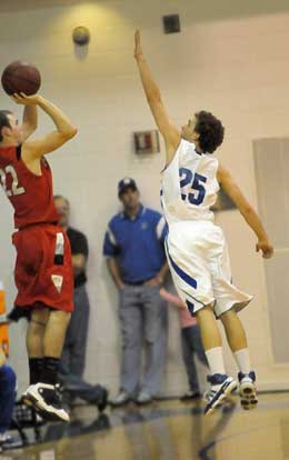 Bryant senior Houston Garner (25) goes up to defend against a 3-point attempt by Cabot's Darin Jones. (Photo by Kevin Nagle)