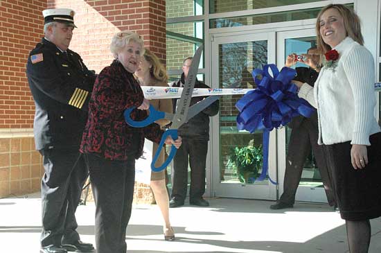 Norma Bishop cuts the ribbon on the new Center at Bishop Park during the grand opening on Jan. 26. Holding the ribbon are Mayor Jill Dabbs, left, and Fire Chief Randy Cox. (Photo by Martin Couch)