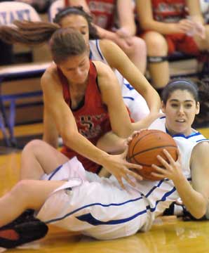 Bryant's London Abernathy tries to retain possession of a loose ball in a battle with Russellville's Mary Carol Davis. (Photo by Kevin Nagle)