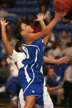 Kiara Moore puts up a shot as she drives past a North Little Rock defender. (Photo by Rick Nation)