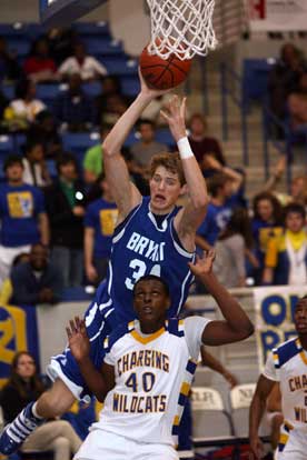 Quinton Motto rebounds over North Little Rock's Cameron Williams. (Photo by Rick Nation)