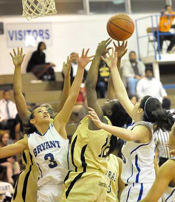 Bryant's McKenzie Adams (3) and London Abernathy battle Central's Dee Dee Arline for a rebound. (Photo by Kevin Nagle)