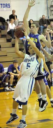 Jordan Griffin (5) is fouled by Little Rock Catholic's Brad Kiernan on his way to the hoop. (Photo by Kevin Nagle)