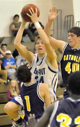 Catholic's Alex Cope (1) takes a charge after Bryant's Quinton Motto drives around Matt Morris (40). (Photo by Kevin Nagle)