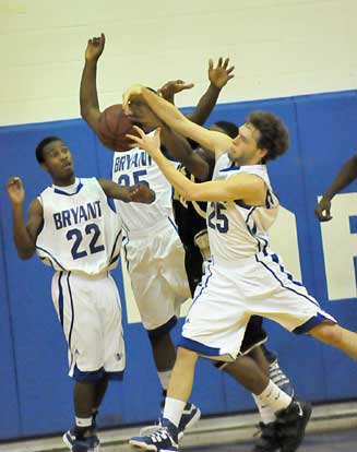 Houston Garner, 25, and Eric Moore, 35, battle for a rebound as Marcus Wilson, 22, prepared to get involved. (Photo by Kevin Nagle)