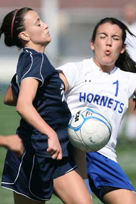 Lexi Balisterri (1) winces as she and a Little Rock Christian player contend for possession of the ball. (Photo by Rick Nation)